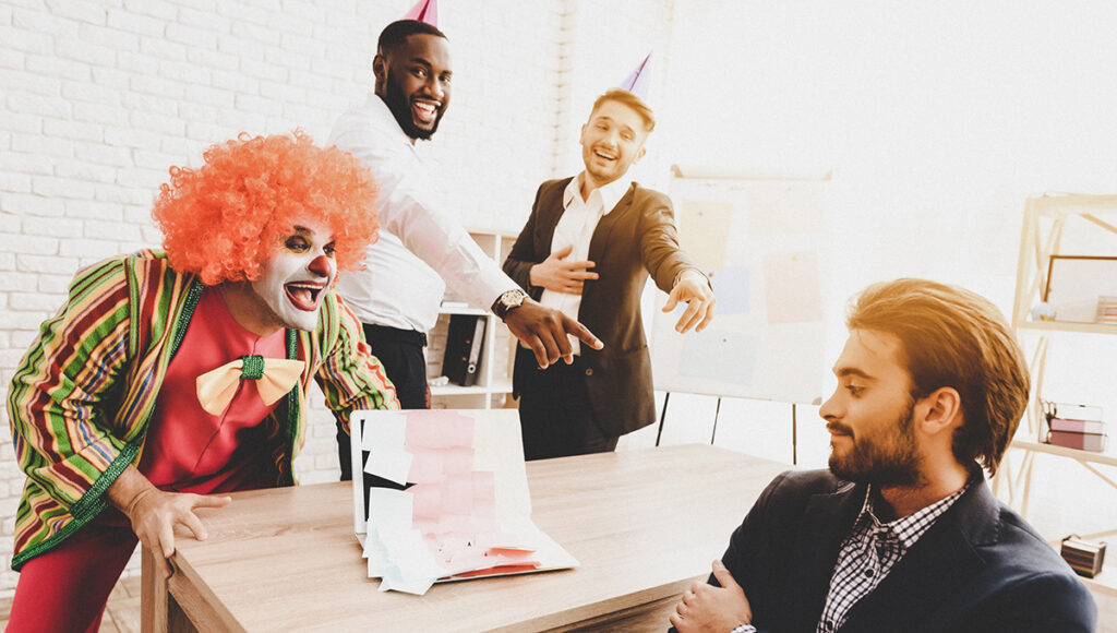April Fools' Day prank with a young Man in a clown costume at a meeting in an office.