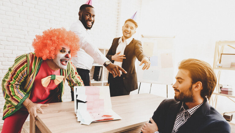 April Fools' Day prank with a young Man in a clown costume at a meeting in an office.