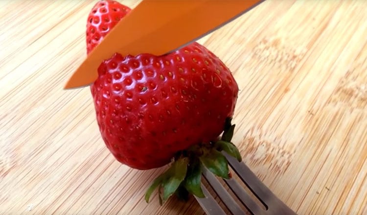 strawberry being cut