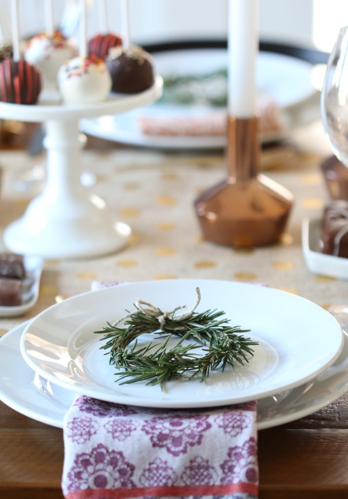 Thanksgiving table with a rosemary wreath on a plate.