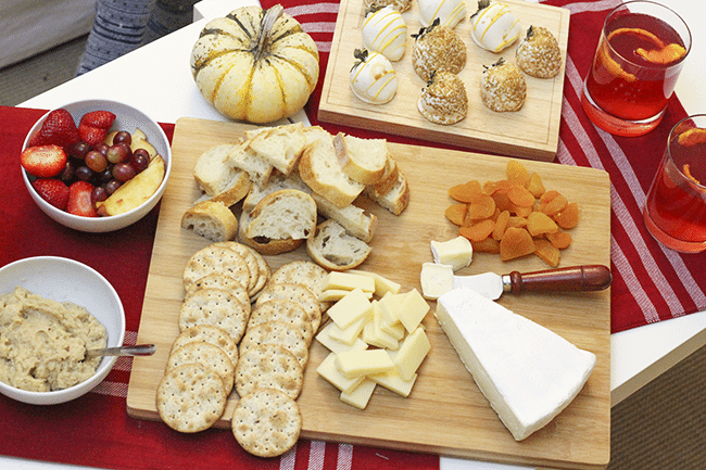 cheese and crackers platter with cranberry champagne cocktail