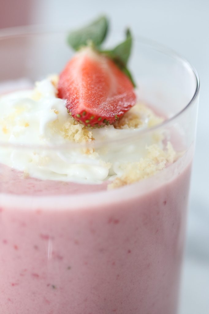 strawberry shortcake smoothie in glass with whipped cream