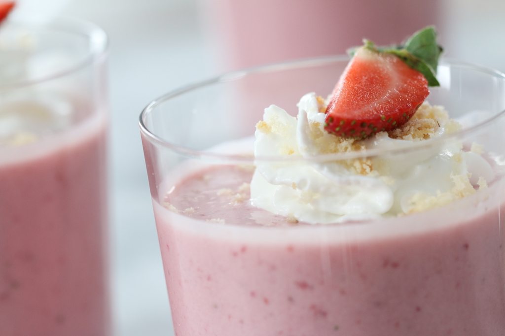strawberry shortcake smoothies close up with whipped cream