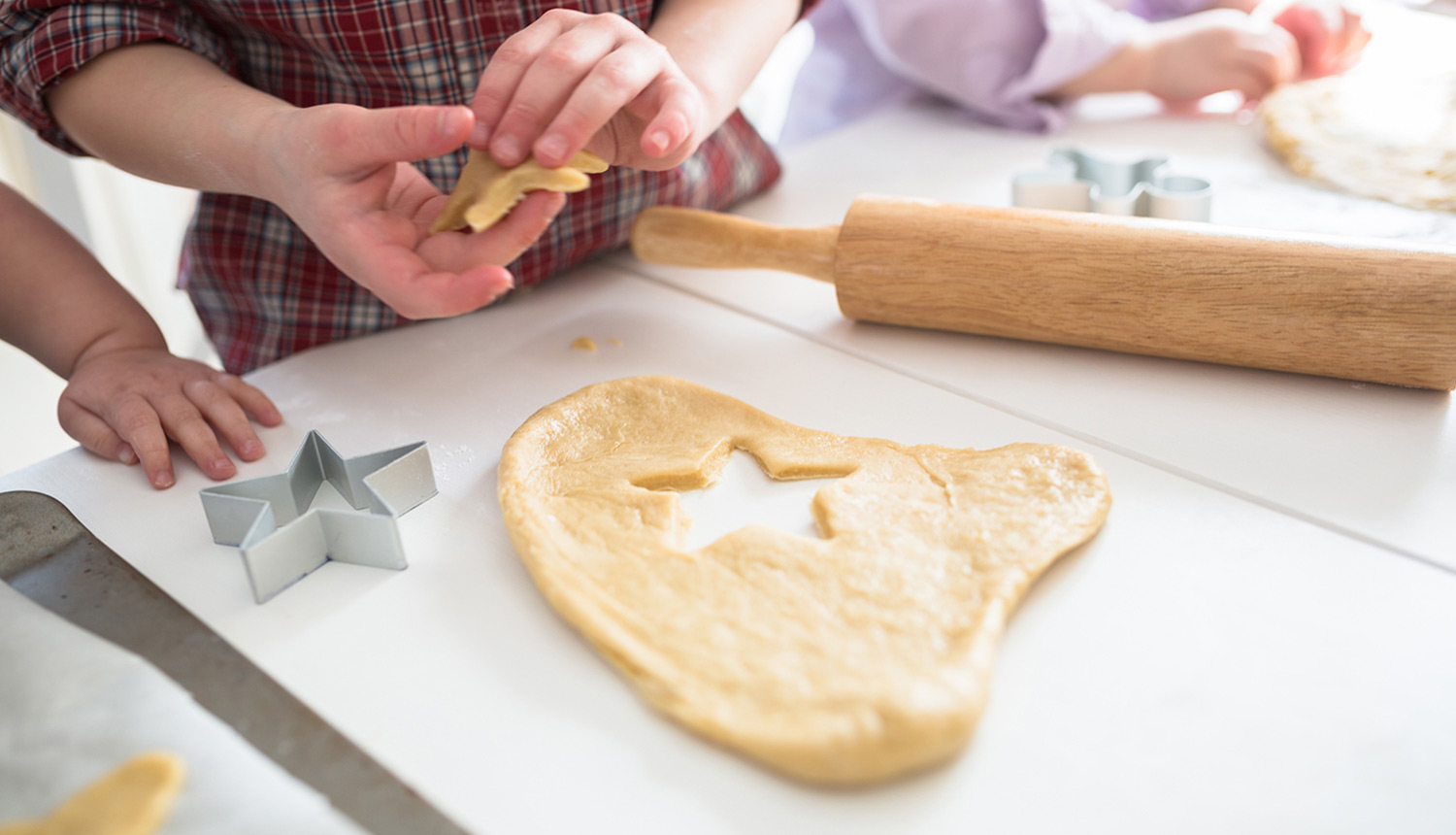 kids making cookies in kitchen