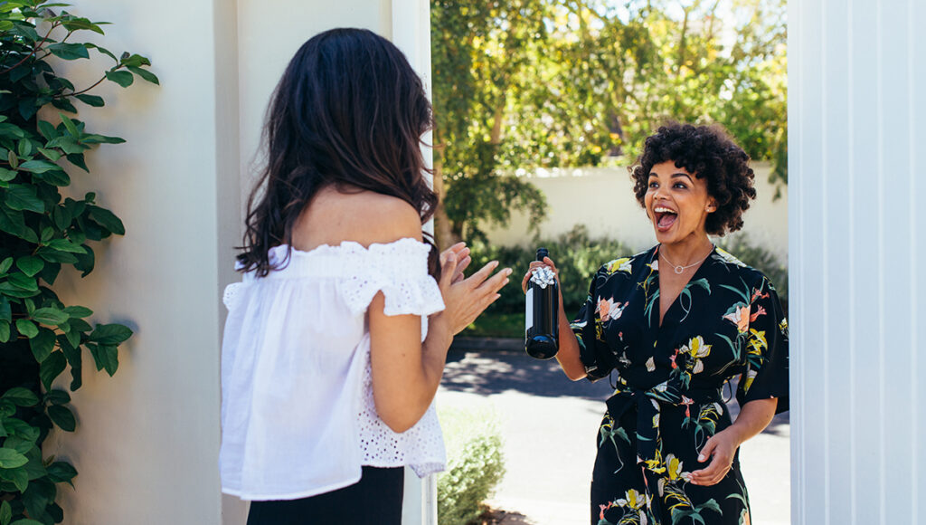 housewarming party ideas with an excited woman with wine bottle for housewarming party